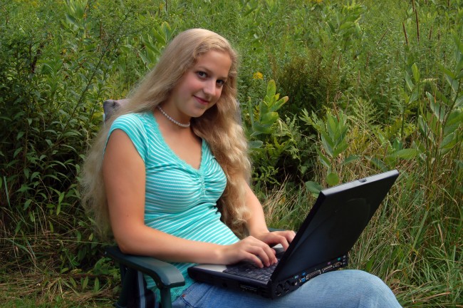 Female student outdoors with computer