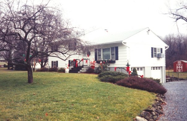My childhood home at Christmas time (no snow) with the horse barn in the backyard. 